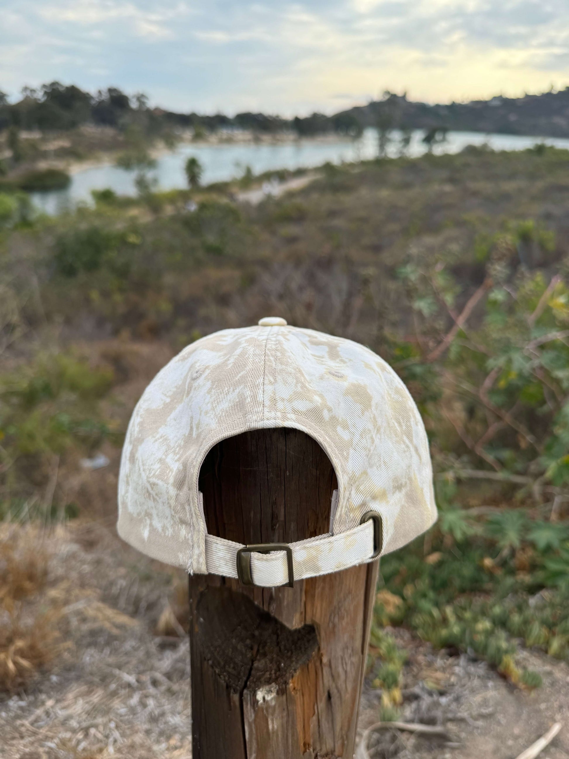 Beige cap on a wooden post with a blurred natural background